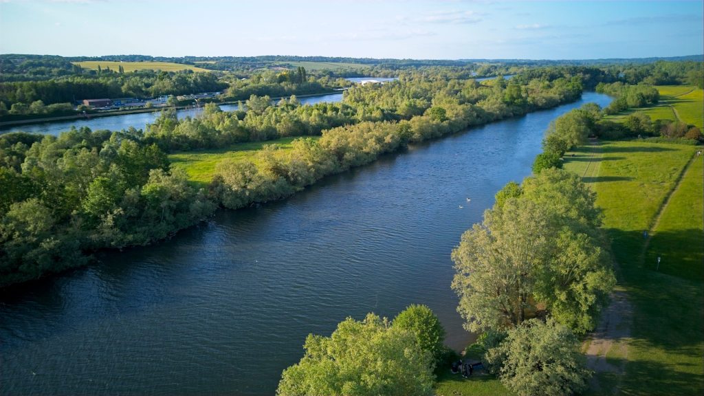 Knights expands in Thames Valley as latest acquisition completes - A view of a river running through a lush green field.