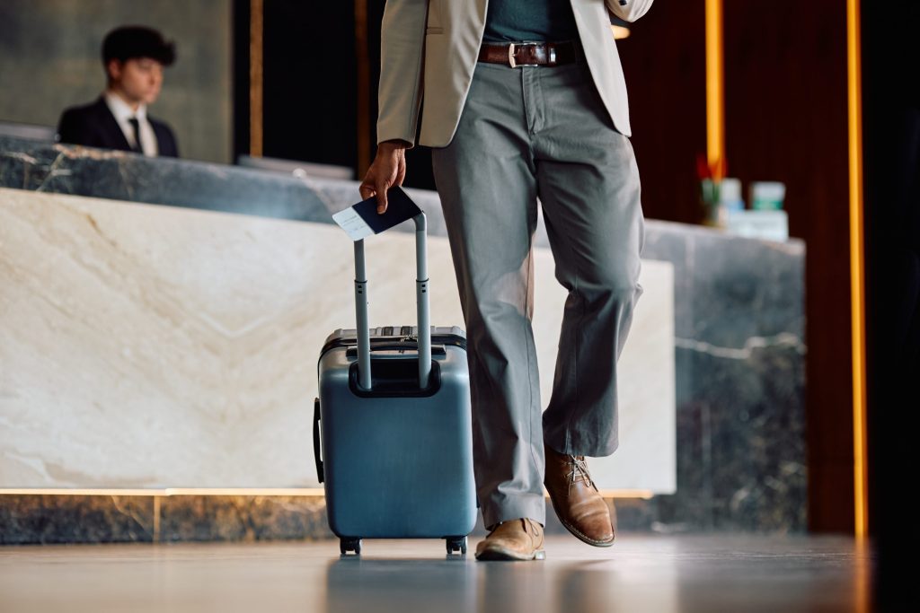 Knights Legal Services - A man in a suit and tie walking with a suitcase.