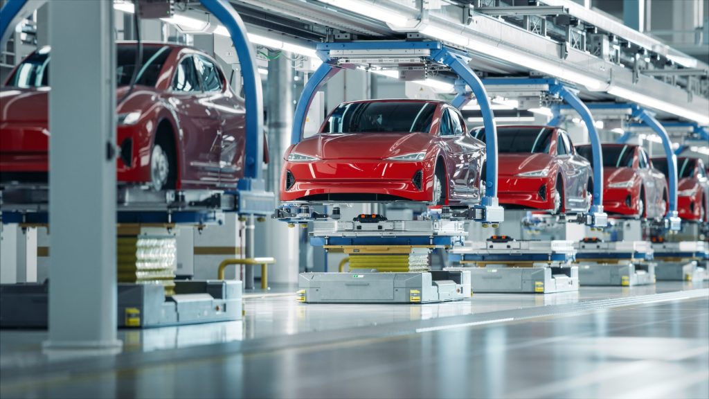 Knights Legal Services - a row of red cars on a conveyor belt in a factory